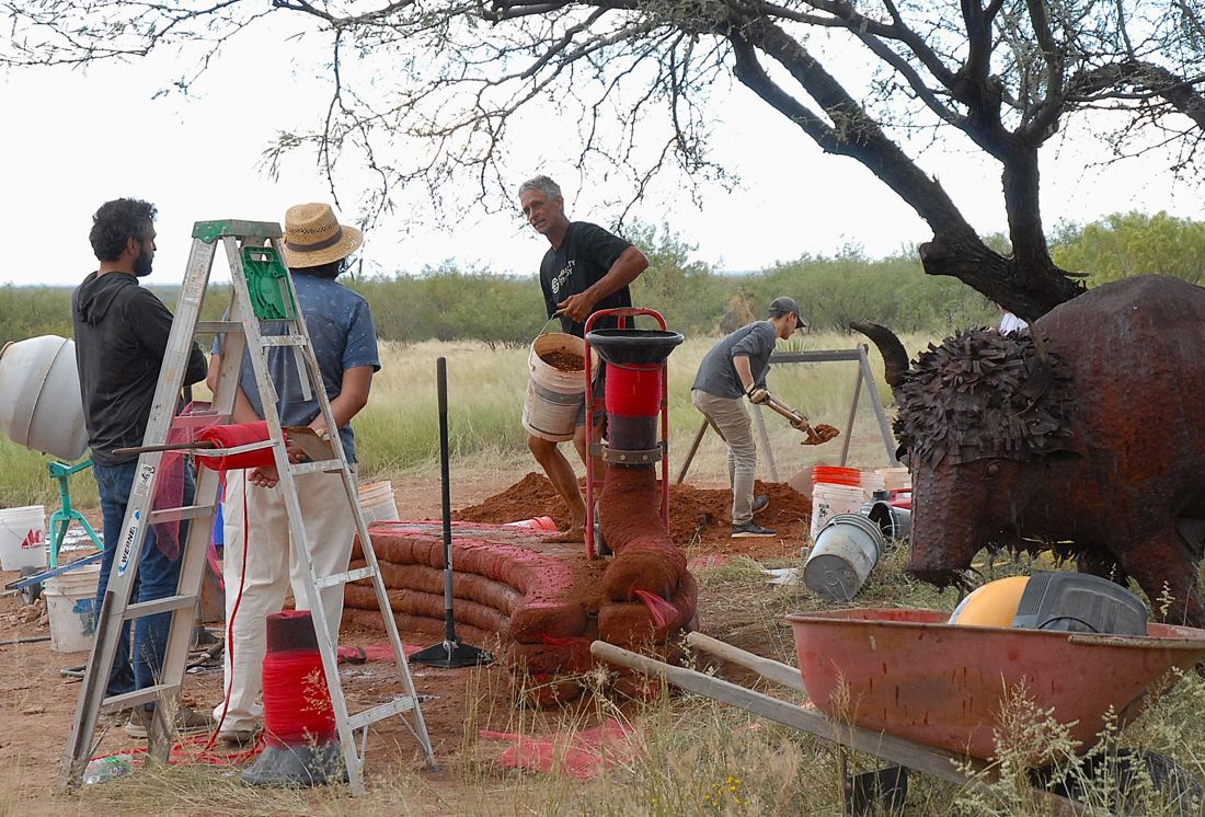 Tamping the earthen bench at the Eco Fest natural build demo
